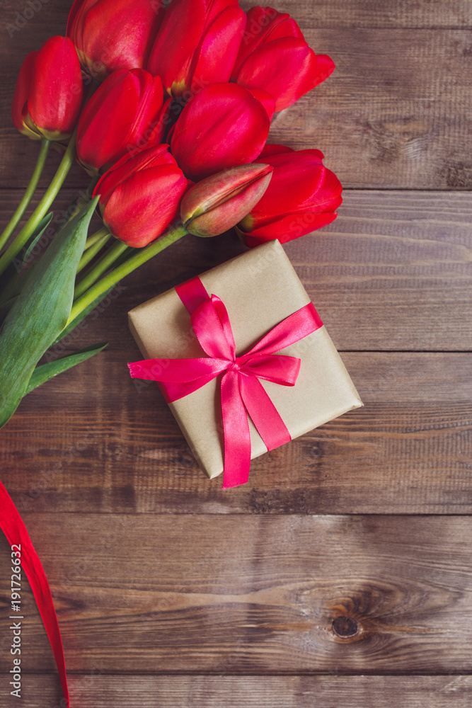 Spring flowers. Bouquet of Red tulips on brown wooden background. Spring flowers. Bouquet of Red tulips on brown wooden background.