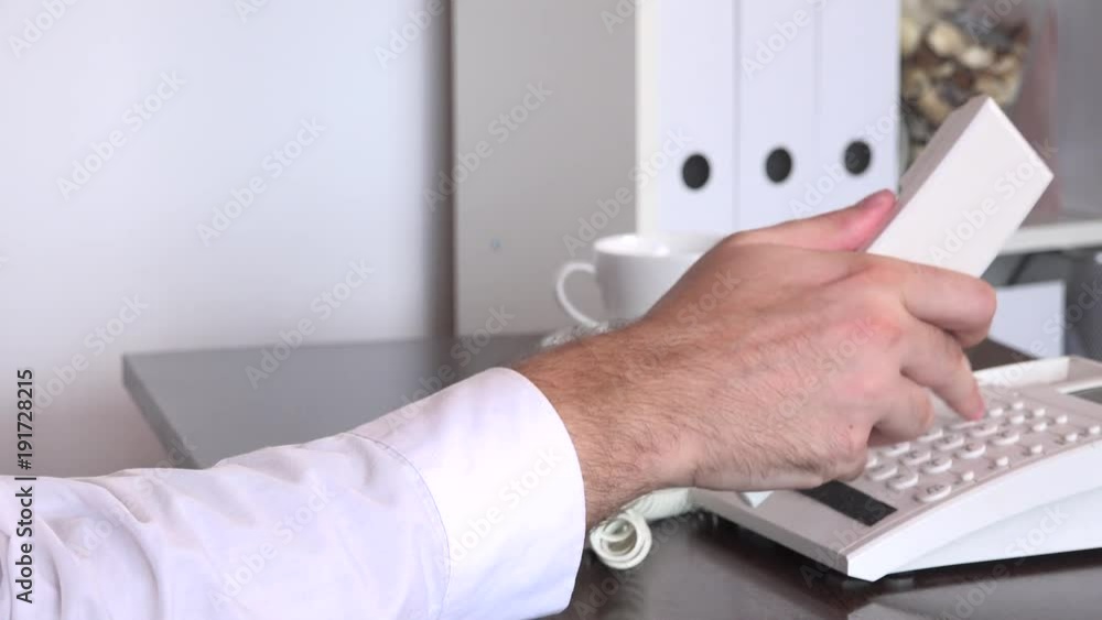 Business man manager in the office closeup hand fingers pushing landline buttons Business man manager in the office closeup hand fingers pushing landline buttons