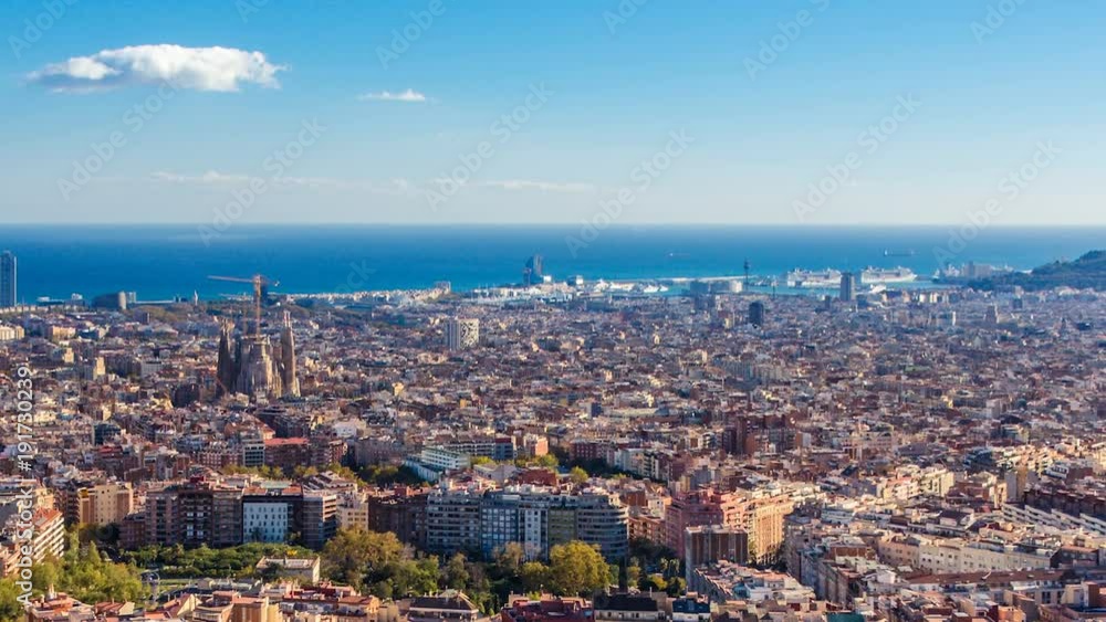 View of Barcelona fom the Carmel Hill, with the Mediterranean sea, the twin towers and The Sagrada Familia Basilica