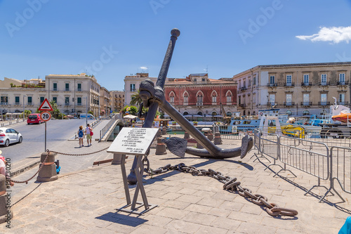 Syracuse, Sicily, Italy. The ship's anchor monument and the Umbertino bridge (1800) to the island of Ortigia photo