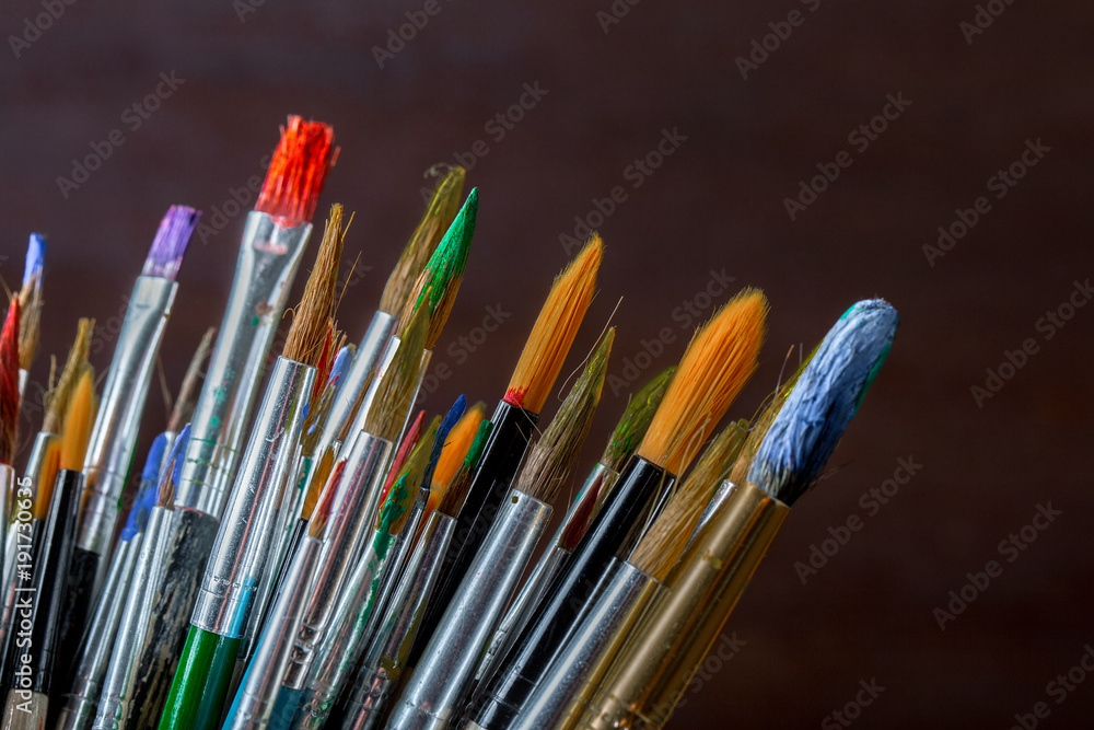 Paints for drawing and brush on a background in a composition Paints for drawing and brush on a background in a composition
