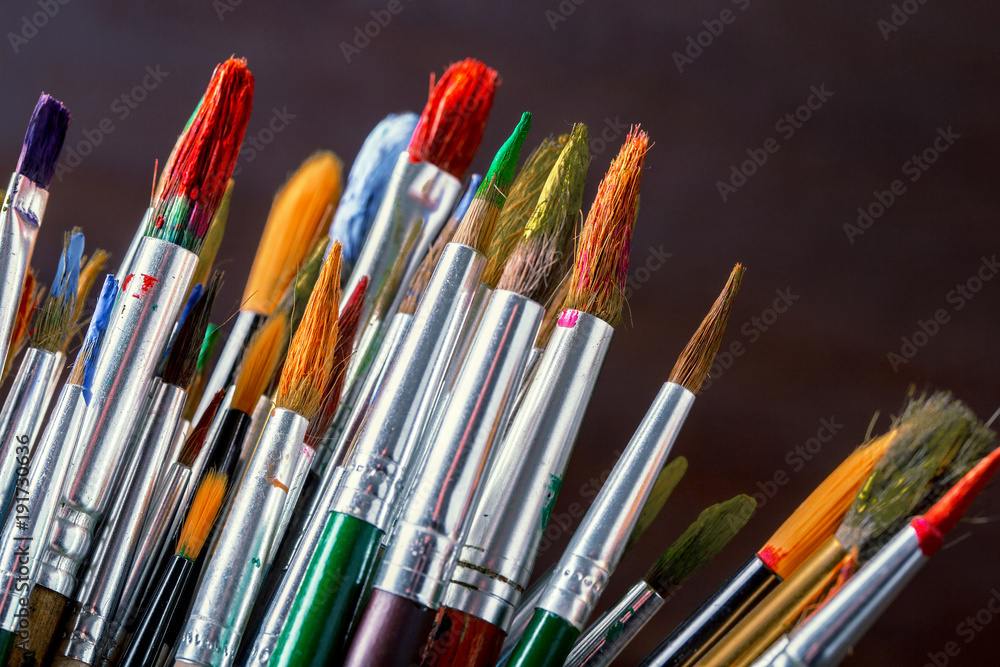 Paints for drawing and brush on a background in a composition Paints for drawing and brush on a background in a composition