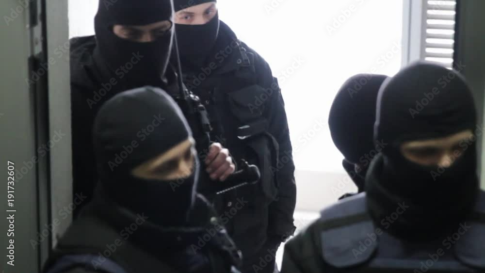 Special forces in masks blocking the entry into the office building. The police conduct a search in the office Special forces in masks blocking the entry into the office building. The police conduct a search in the office