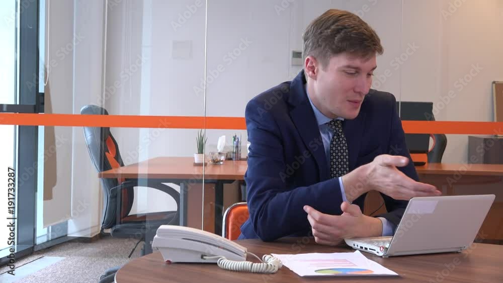 Cheerful joyful optimistic formal accountant banker talking indoors to colleague Cheerful joyful optimistic formal accountant banker talking indoors to colleague