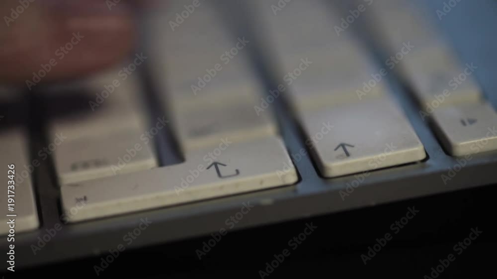 Male fingers typing text on slim computer dirty bristles keyboard, macro close up Male fingers typing text on slim computer dirty bristles keyboard, macro close up