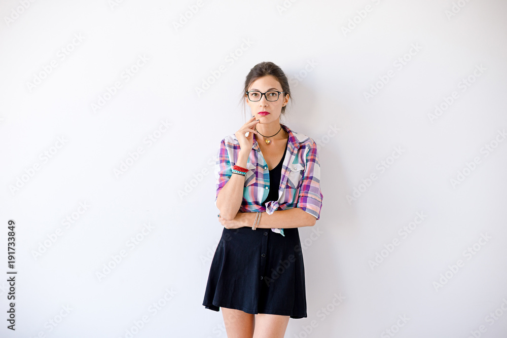 Young woman wearing fashionable glasses and plaid colorful shirt Young woman wearing fashionable glasses and plaid colorful shirt