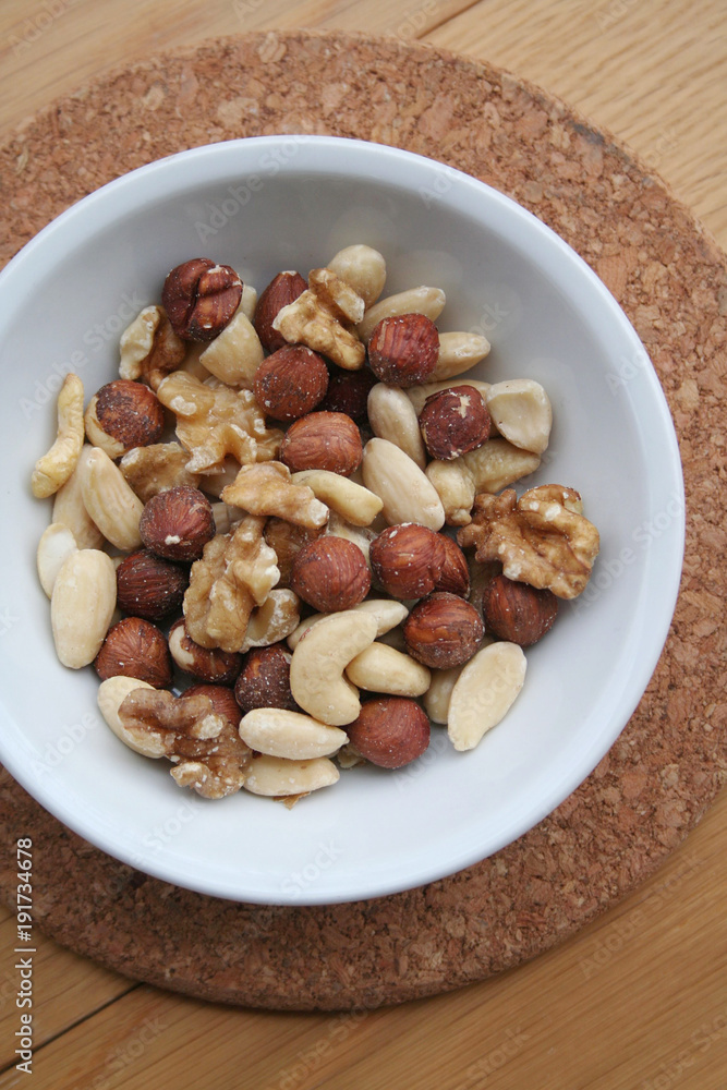Mixed nuts in a bowl on wooden background
Mixed nuts in a bowl on wooden background