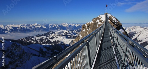 Sex Rouge, mountain peak in the Swiss Alps. Suspension bridge connecting two peaks. Travel destination in Switzerland.