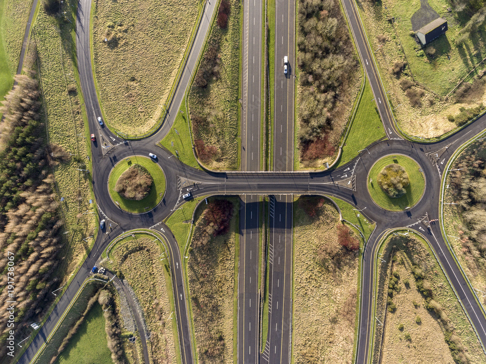 Aerial birds eye view of the M7 motorway in Ireland. Motorway with bridge, roundabouts, and movement.