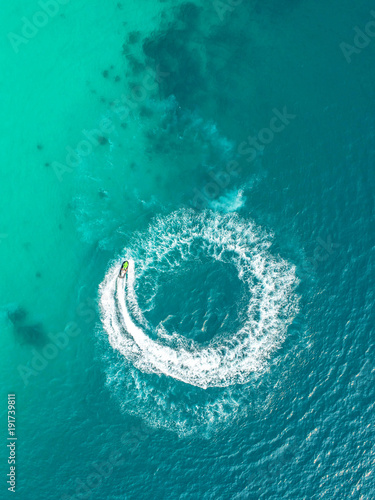 People are playing a jet ski in the sea.Aerial view. Top view.amazing nature background.The color of the water and beautifully bright. Fresh freedom. Adventure day.clear turquoise at tropical beach