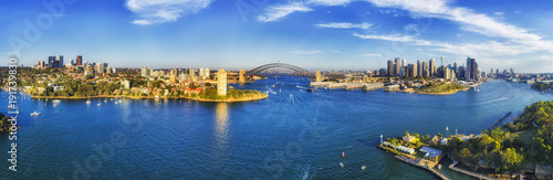 WIde panorama of Sydney city landmarks around Harbour from North Sydney via Sydney Harbour bridge to the rocks and Barangaroo.