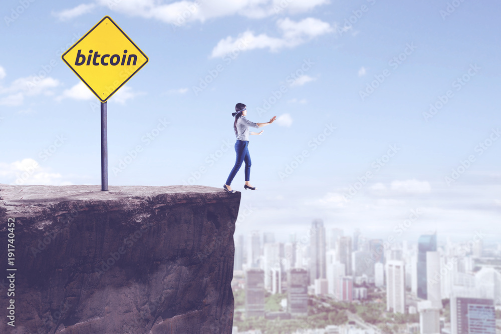 Blindfolded businesswoman with bitcoin word Blindfolded businesswoman with bitcoin word
