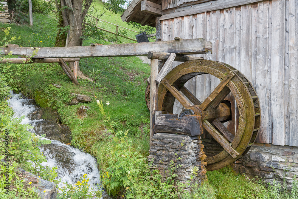 Traditional wooden waterwheel near Werfen in Pongau valley, Austria. The water-wheel was used to generate power for crunching cereals Traditional wooden waterwheel near Werfen in Pongau valley, Austria. The water-wheel was used to generate power for crunching cereals