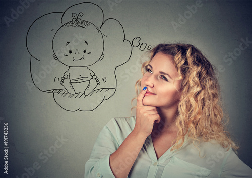 Young woman dreaming of baby