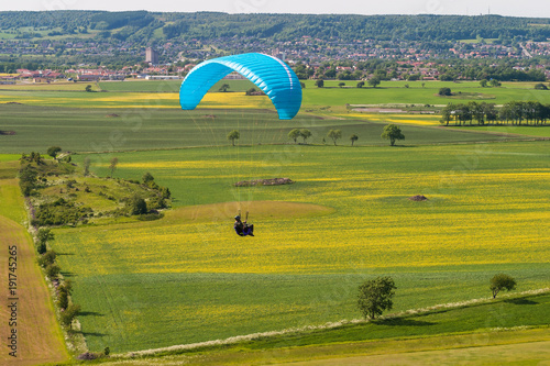 Paragliding over a rural Swedish landscape