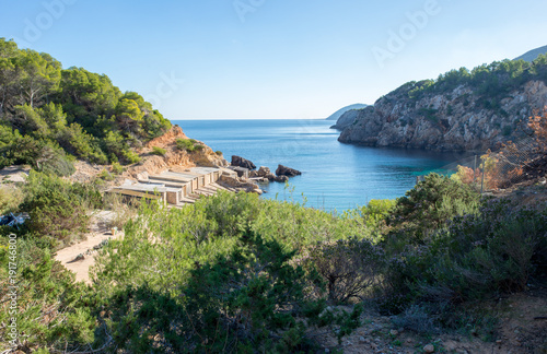 The cove will be with blue water on the island of Ibiza