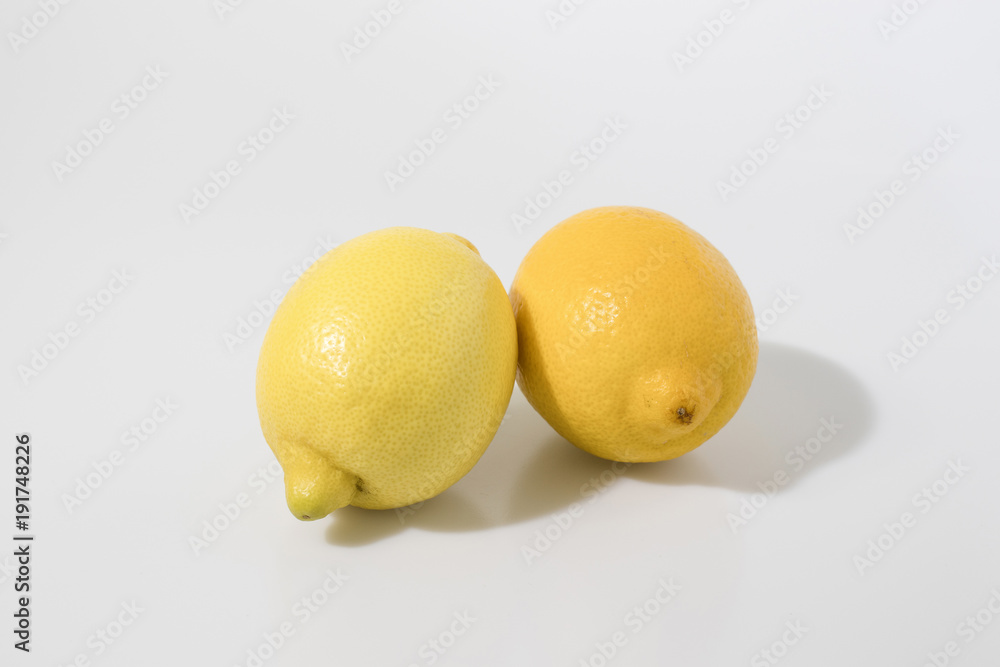 Couple of lemons in a white background composition Couple of lemons in a white background composition