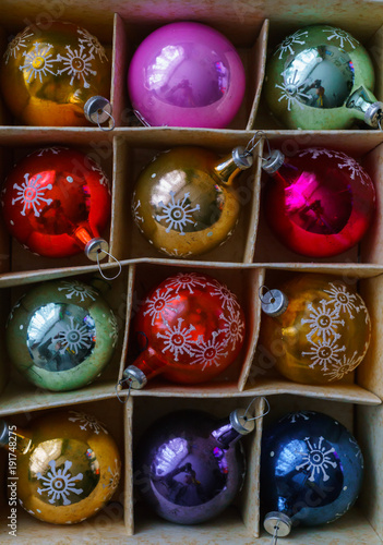 Set of 12 Luxury Winterberry Glass Baubles. Retro styled image of vintage Christmas decoration in a box. Christmas holidays composition. Box filled with christmas multi-colored baubles