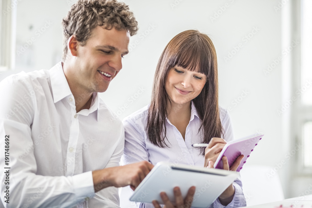 Young business people discussing together in office Young business people discussing together in office