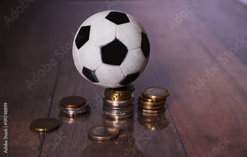 A Football or soccer ball and a pile of money