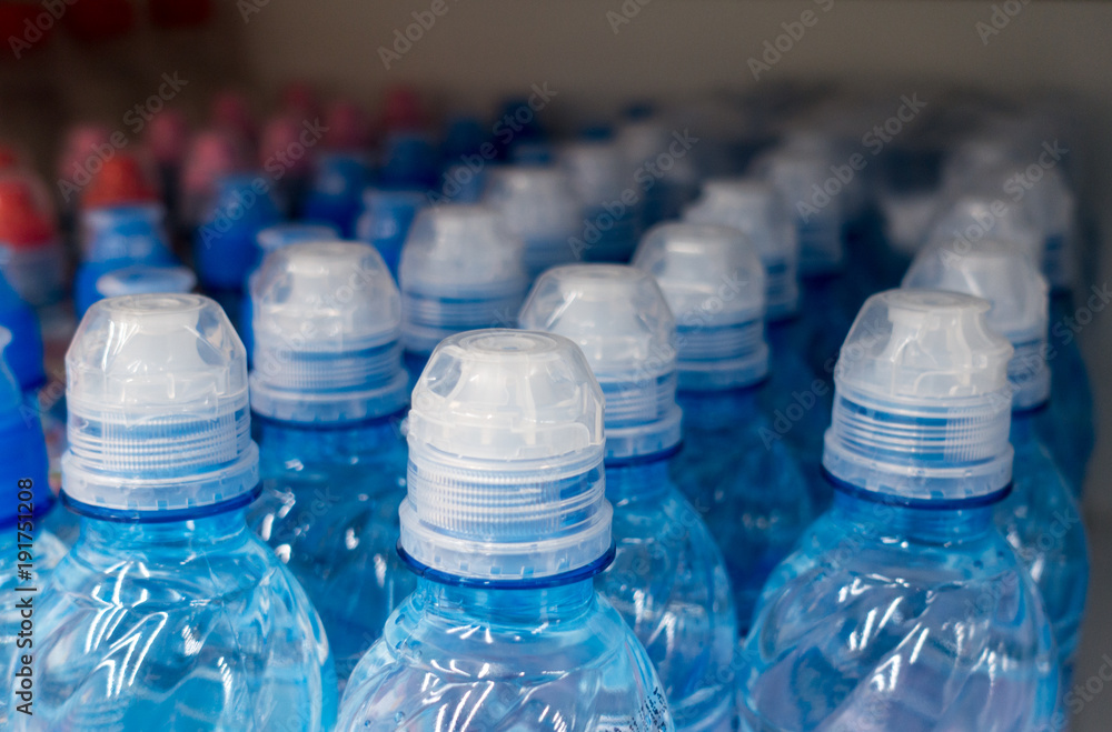 Plastic bottles, colorful caps. Plastic bottles with water, lids. Plastic bottles, colorful caps. Plastic bottles with water, lids.