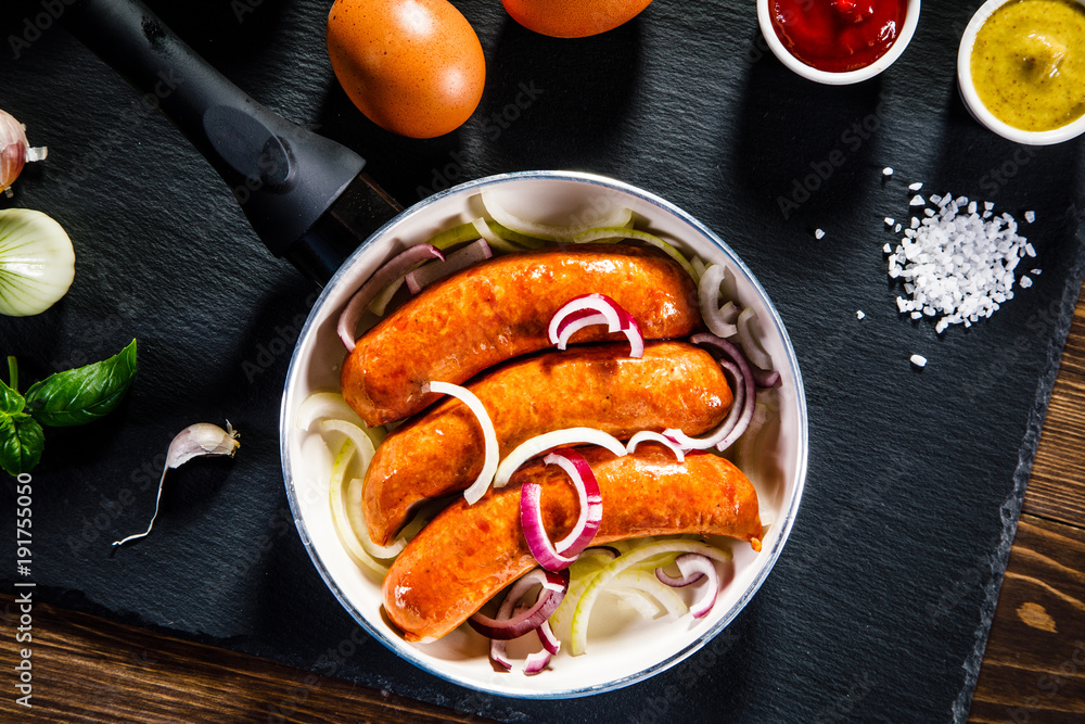 Sausages in pot on black stone Sausages in pot on black stone