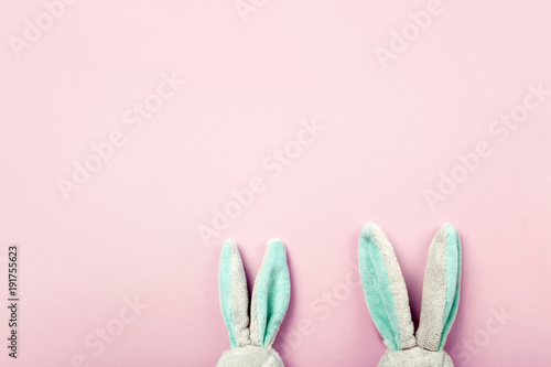 Toy rabbits ears, flatlay on pink background with copy space for text.