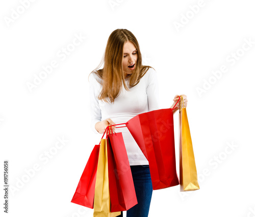 Young woman holding shopping bags isolated on white background
