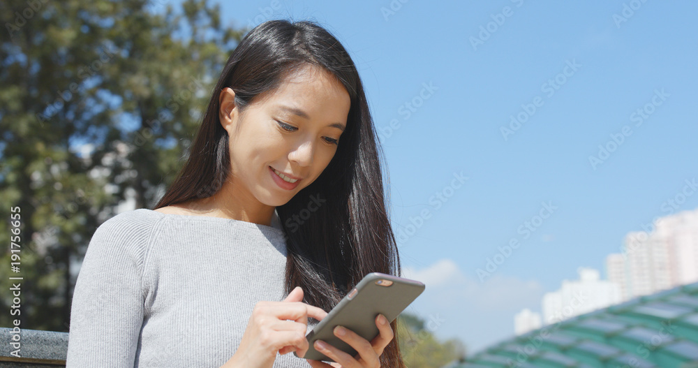 Fototapeta premium Woman use of mobile phone at outdoor