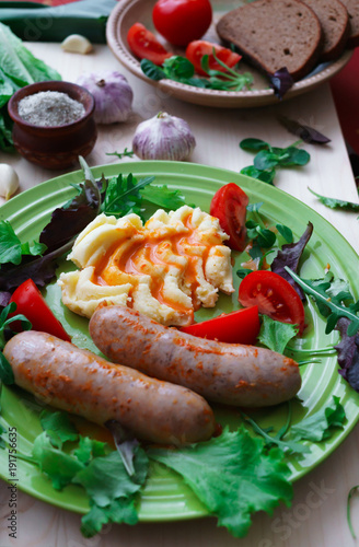 Home-made Pork Sausages along with mashed potatoes, poured with sweet paprika sauce.