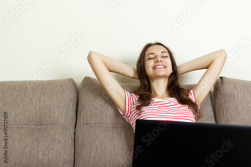 Asian girl relaxing at home with laptop photo