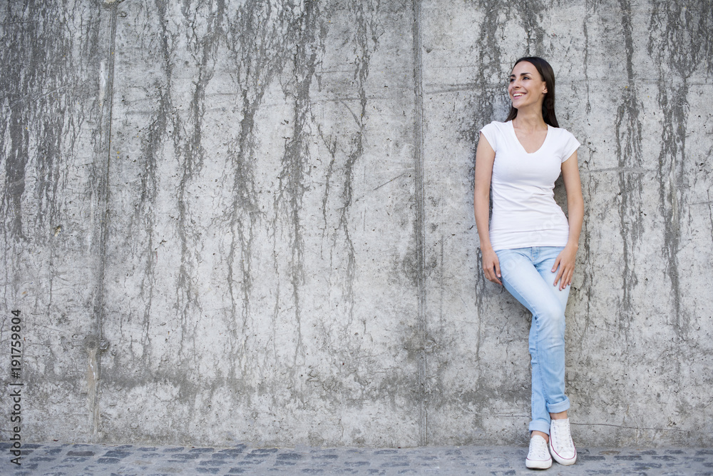 Everything will be cool. Attractive young woman near a concrete wall. Everything will be cool. Attractive young woman near a concrete wall.