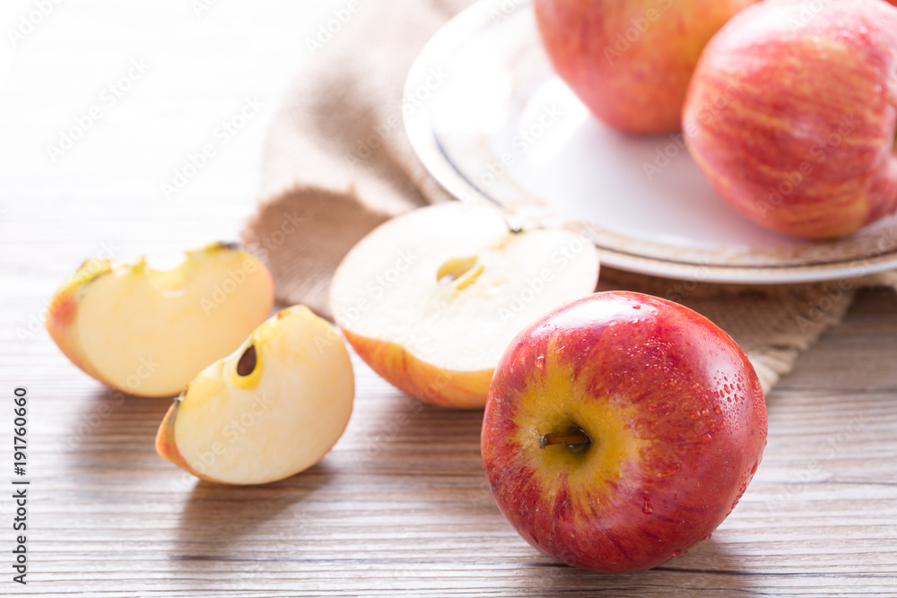 Fresh red apple and slices on wooden table. Closeup Fresh red apple and slices on wooden table. Closeup