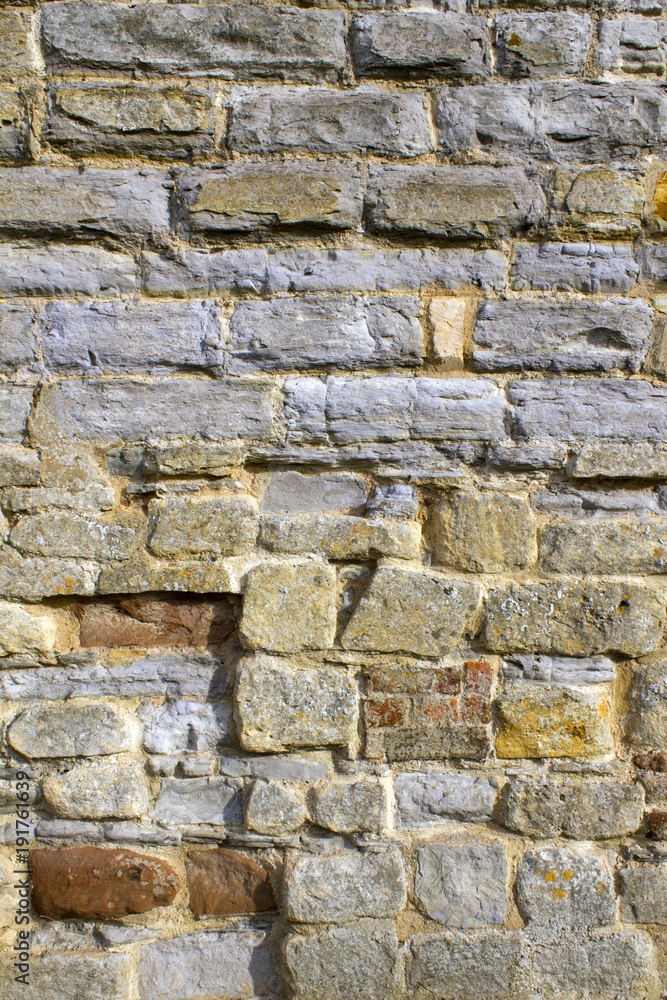Stone and brick texture on an old worn and repaired wall, Tewkesbury, Gloucestershire, Severn Vale, UK Stone and brick texture on an old worn and repaired wall, Tewkesbury, Gloucestershire, Severn Vale, UK