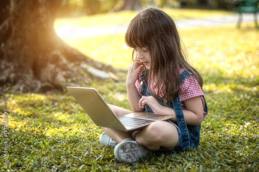Children playing tablet in the garden.Soft focus concept. Children playing tablet in the garden.Soft focus concept.