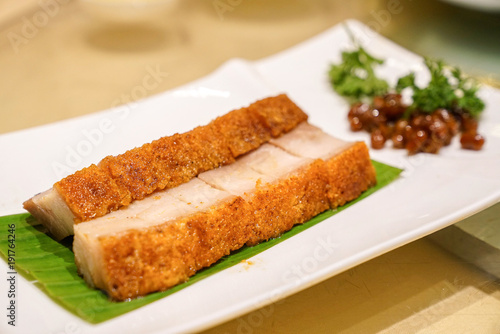 Pork crispy hong kong chinese style on white dish in chinese food restaurant