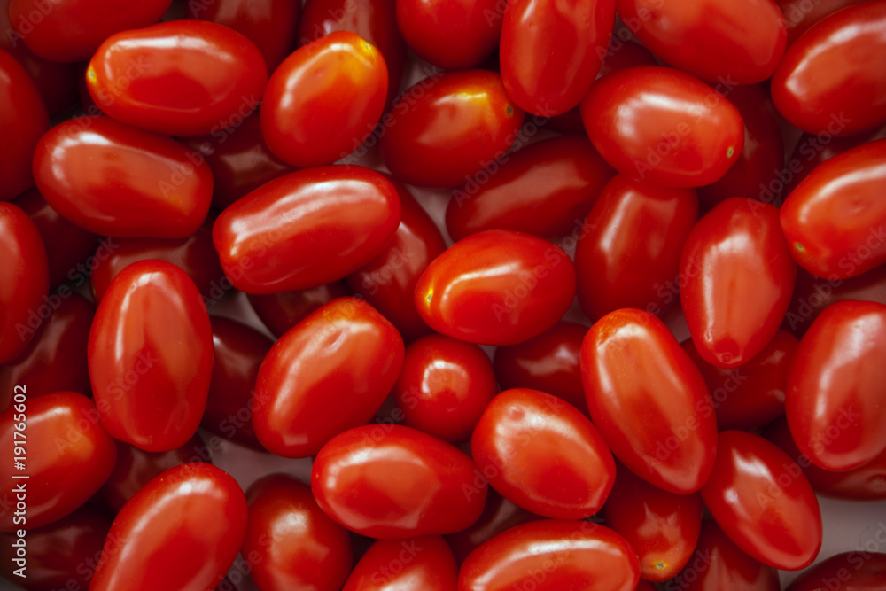 Full frame vibrant red miniature plum tomatos Full frame vibrant red miniature plum tomatos