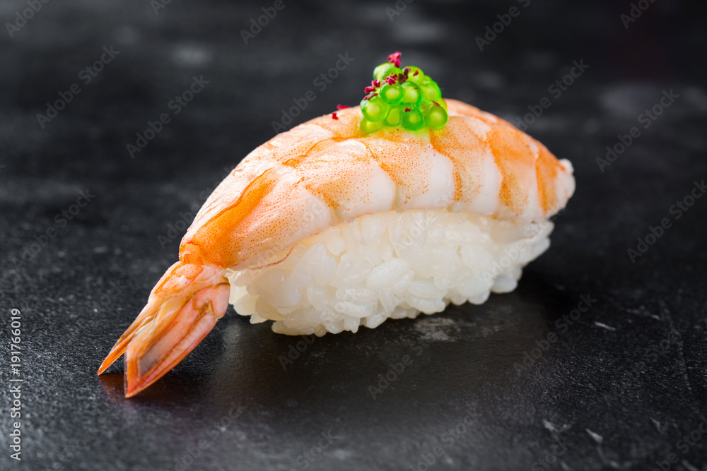 Sushi nigiri with shrimp on black background