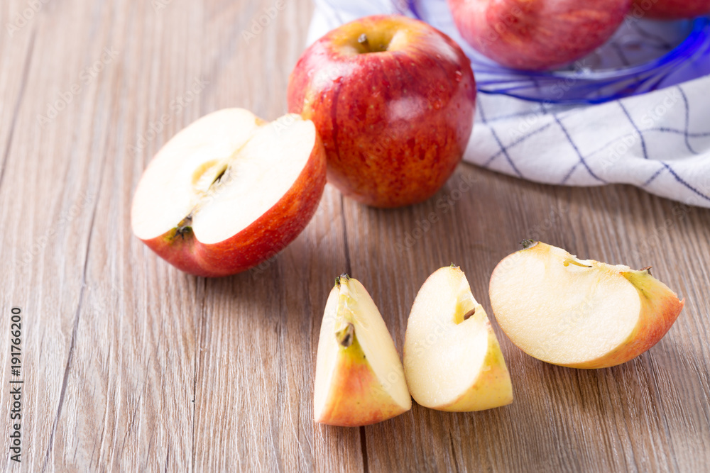 Fresh red apple and slice on a wooden table. Fresh red apple and slice on a wooden table.