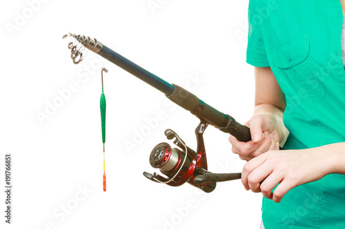 Person holding fishing rod, spinning equipment.