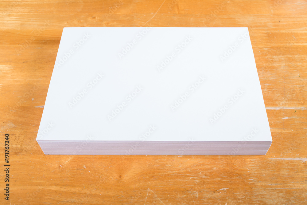 White paper on wood table White paper on wood table