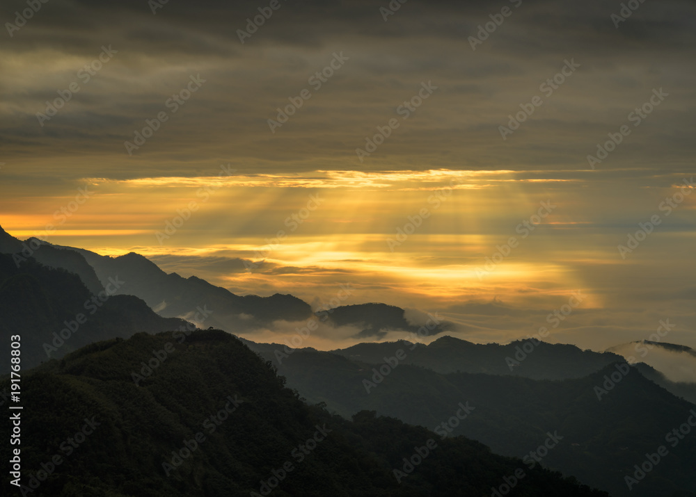 Clouds and sunrays in the mountains of Alishan in Taiwan.