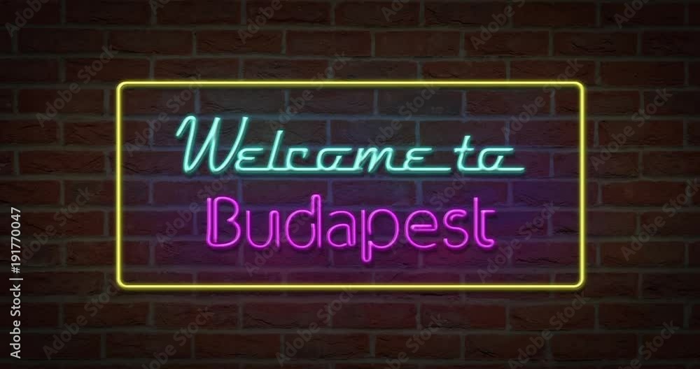 Neon text sign of Welcome to Budapest in brick background Neon text sign of Welcome to Budapest in brick background