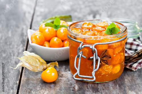 Homemade  physalis jam in jar on wooden table