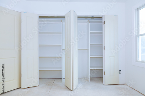 With a shelf near of big cabinet. Furniture installation.