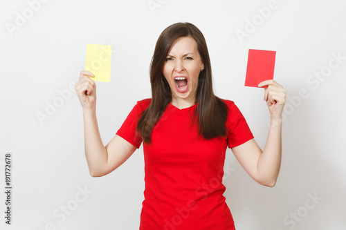 European serious severe young woman, football referee hold choose yellow and red soccer cards, propose player retire from field isolated on white background. Sport, play, healthy lifestyle concept. photo