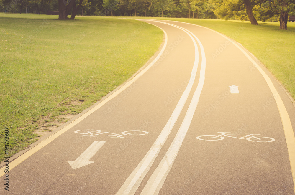 Fototapeta premium bicycle path along the park/bicycle path along the park in sunrise