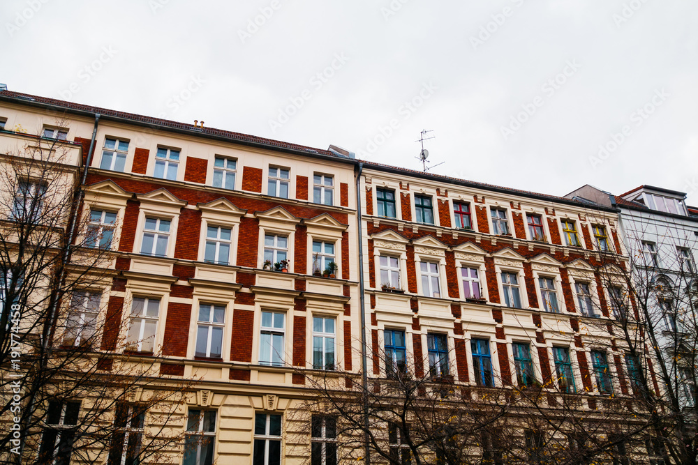 Fototapeta premium Vintage style apartment buildings with red facade