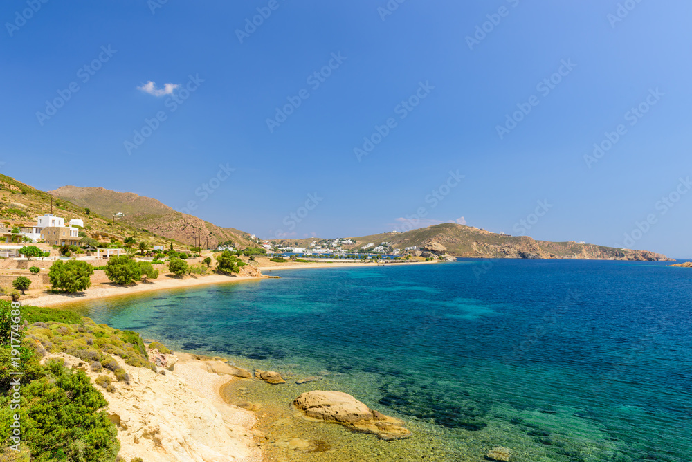 Petra beach is a picturesque beach with clear blue water, Patmos island, Dodecanese Islands, Greece. Petra beach is a picturesque beach with clear blue water, Patmos island, Dodecanese Islands, Greece.