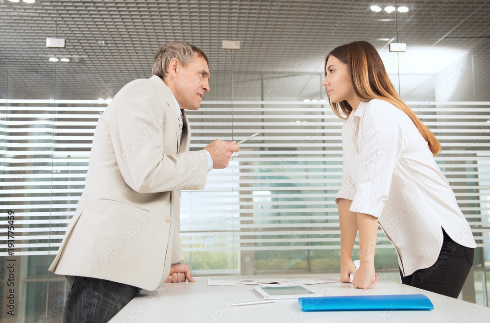 Fototapeta premium man and woman working in bright office classic suits and talk, solve the issues of the company